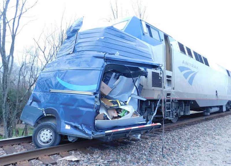 NEAR MISS: Amazon Driver Truck Cut In Half By A Train (VIDEO)